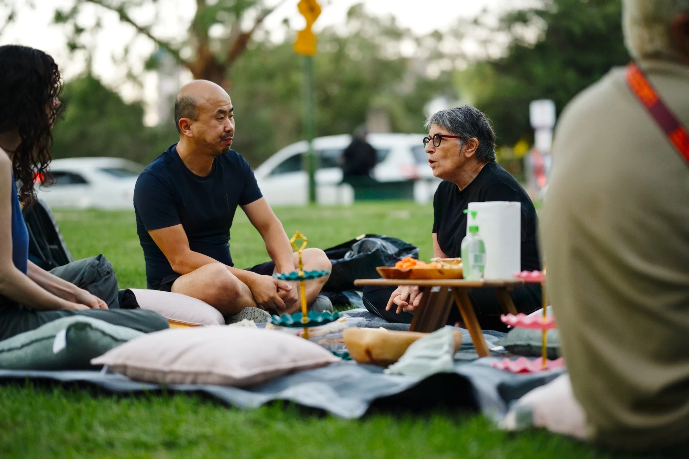 A man and a woman talking at a picnic